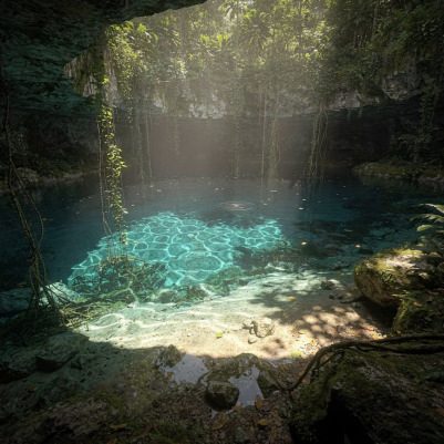 Sunlight falling into an open jungle cenote