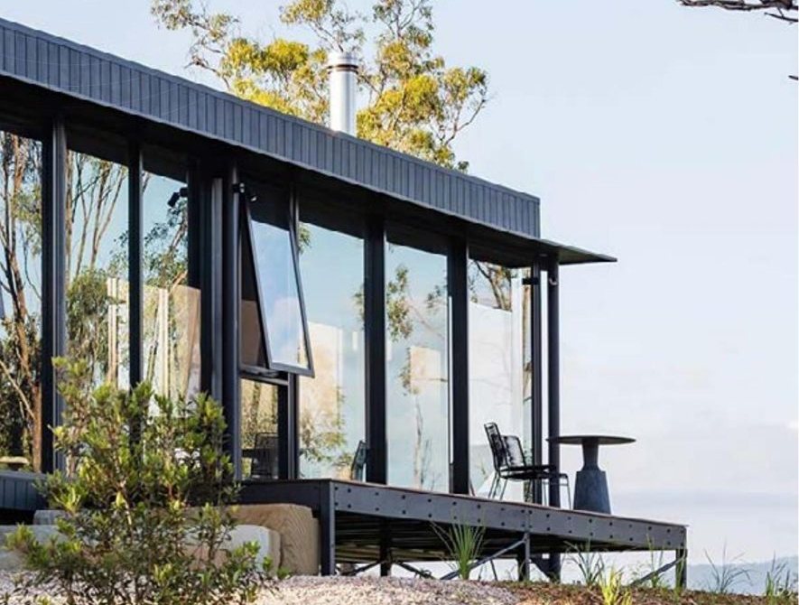 Sample glamping unit: glass-walled cabin on a raised deck